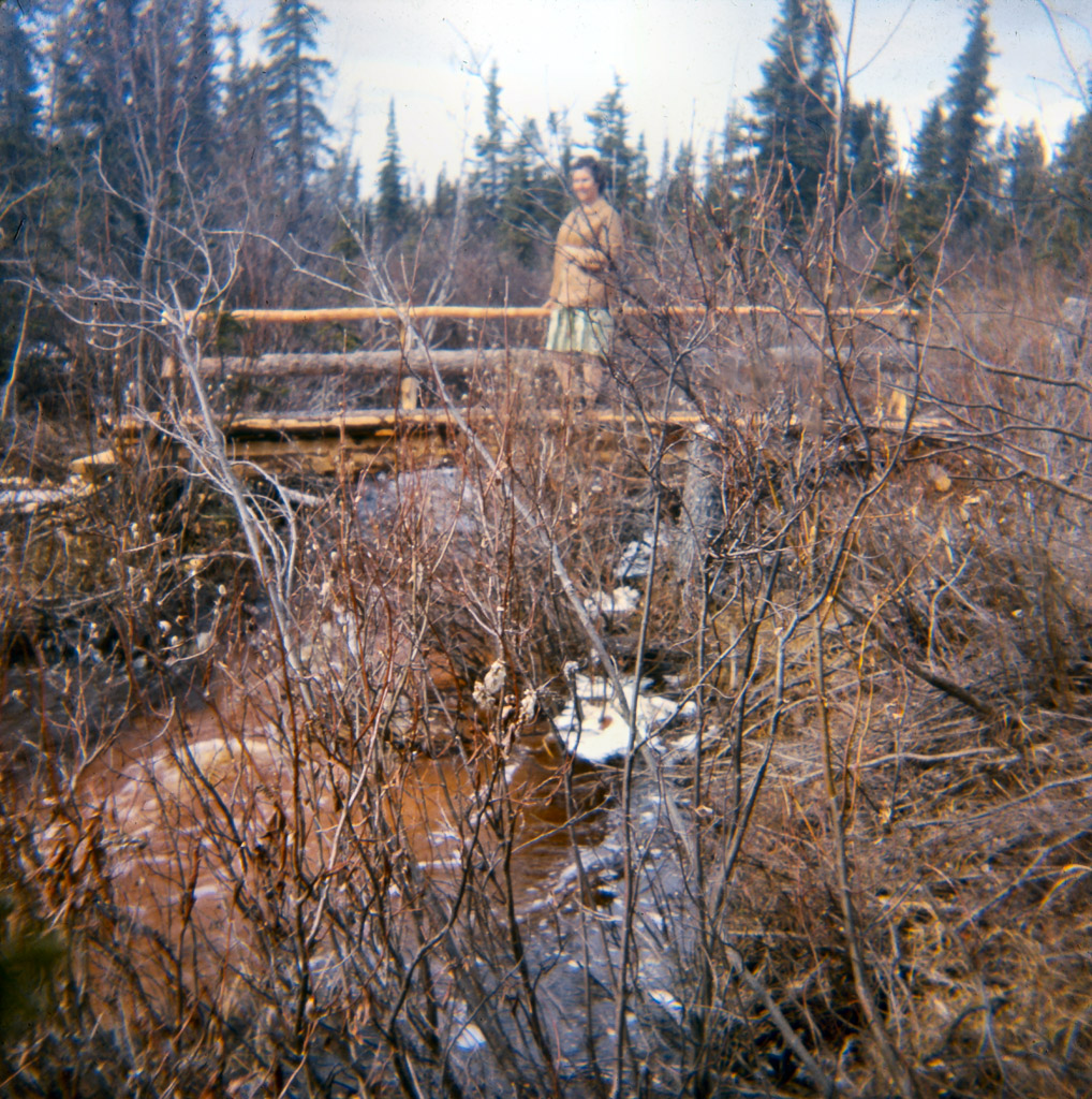 1960s Lorene on bridge Oliver built across our creek This was the trail to town.