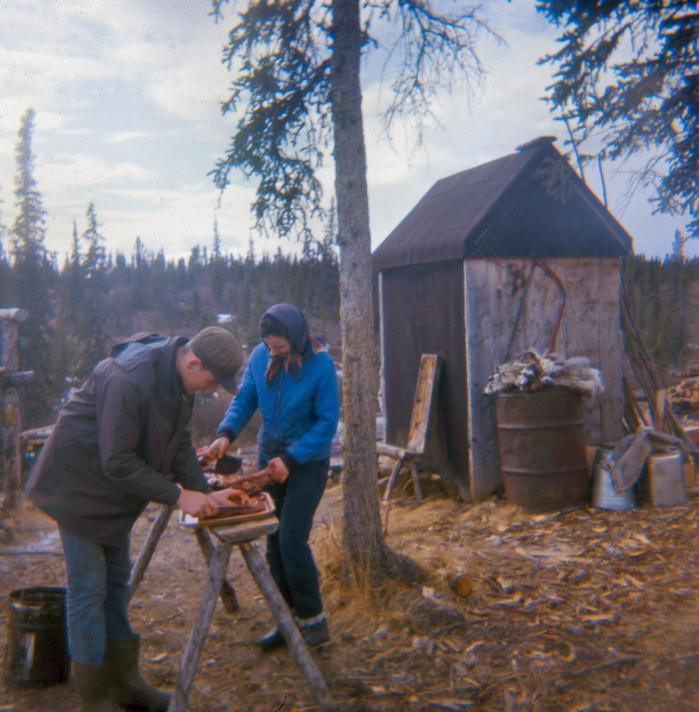 Late 1960s Gary and Dorene cutting caribou meat for drying.tif