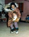 1950s A mother putting baby on her back underneath the parka. Wolf and wolverine ruff.