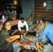 1960s Meal time in Kiana.  Dora Johnson on the left.  Eating frozen fish, dried fish, and seal oil.