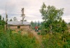 Joyce and Dan Denslow by a village cabin. Ambler, Alaska, 1964.