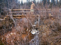 1960s Lorene on bridge Oliver built across our creek This was the trail to town.