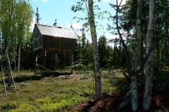 Pole cache with metal roof at the Lake.